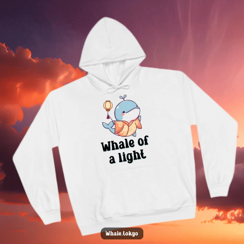 Funny hoodie showing a whale in a kimono playfully nudging a floating lantern, offering cozy enchantment.