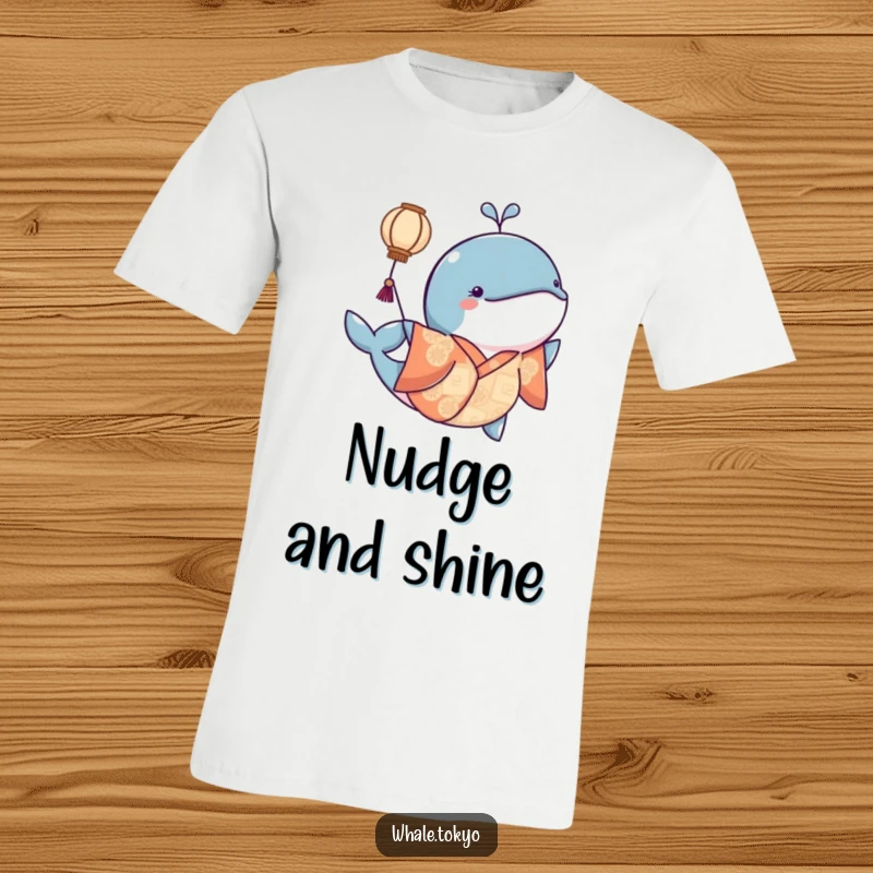 Funny t-shirt featuring a whale in a patterned kimono playfully nudging a floating lantern, creating a soft, magical scene.